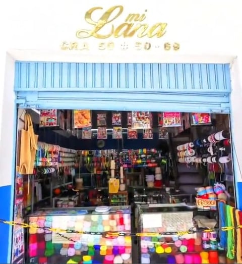 Colorful retail storefront with blue corrugated metal facade and display window filled with merchandise and decorative items